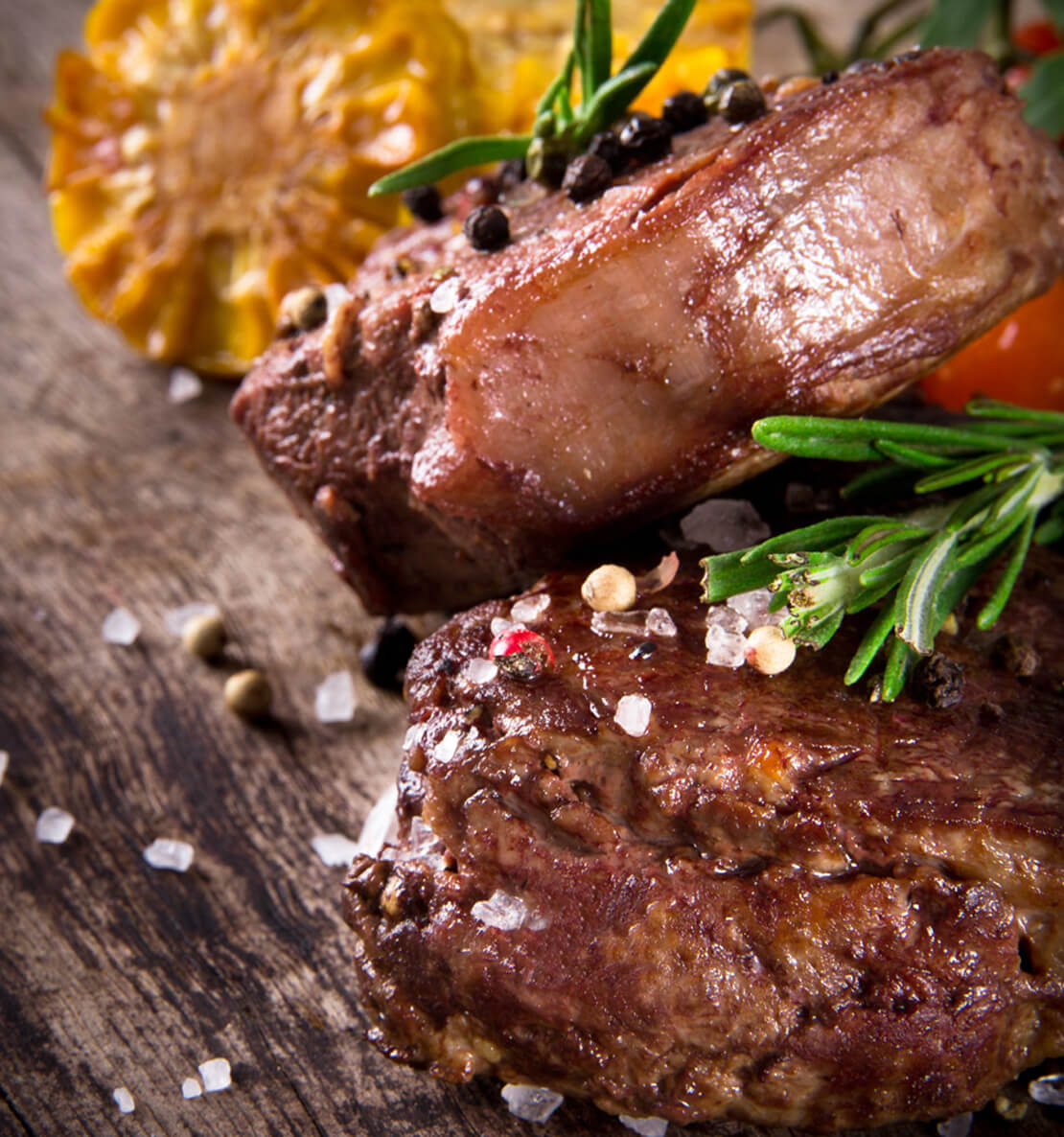 The Lord Lyndoch Barossa Restaurant photo of juicy steak with roasted corn on the cobb on a wooden chopping board.